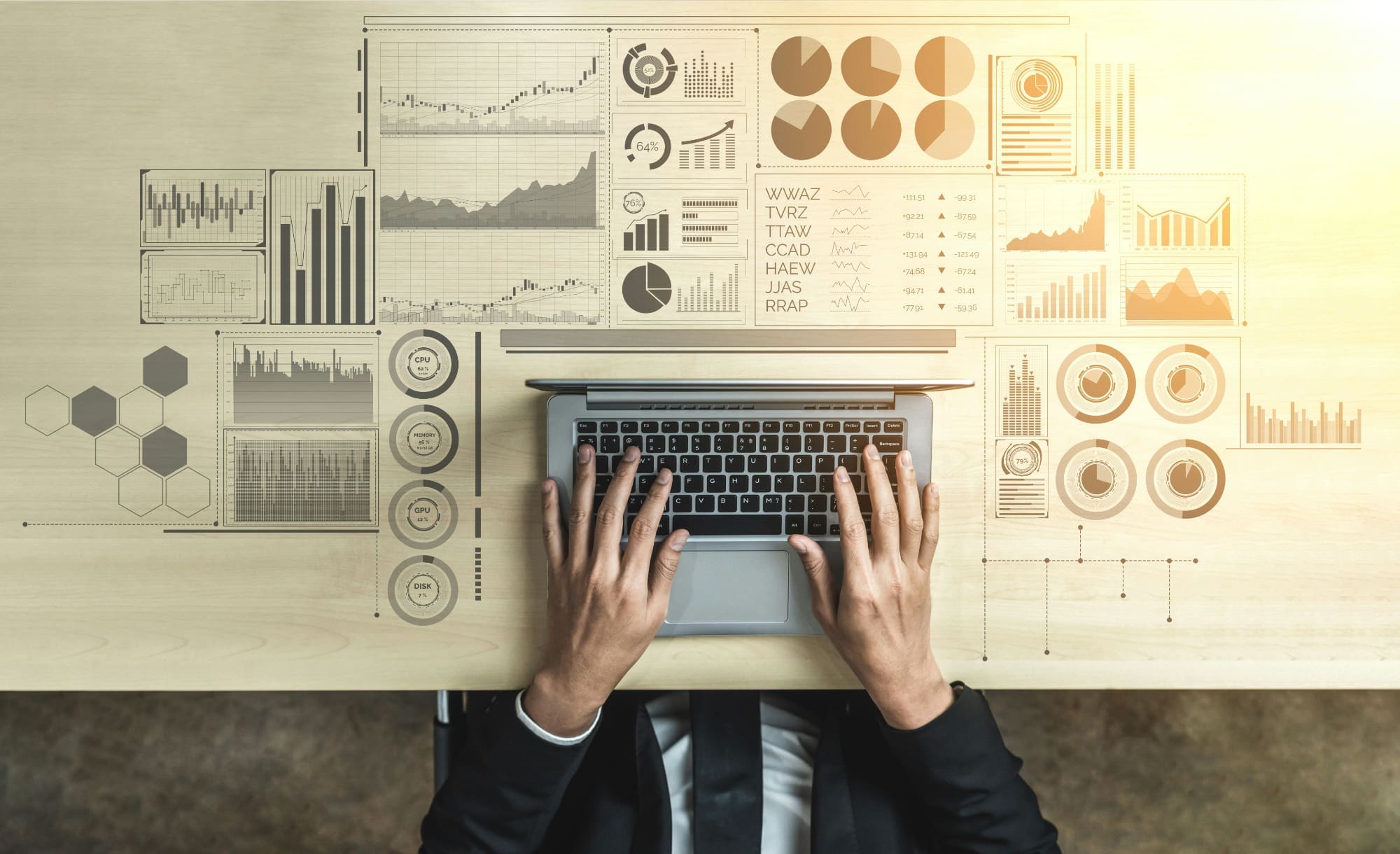 An above-view image of somebody typing on laptop keyboard, with laptop surrounded by super-imposed business graphs.